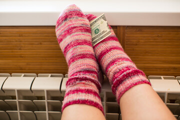 Feet in warm winter socks warm up on the radiator.
