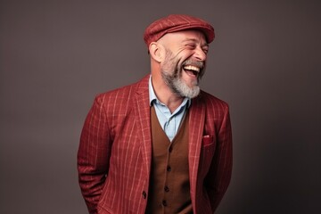 Portrait of a happy senior man in a red jacket and beret.