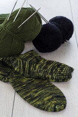 wool yarn, knitting needles and other tools for hand knitting.