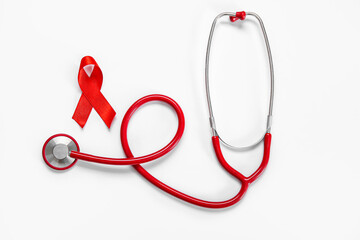 Red ribbon with stethoscope on white background. AIDS Day concept