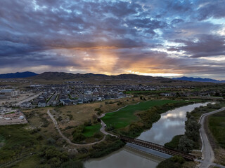 Suburb at sunset by a golf course - aerial view