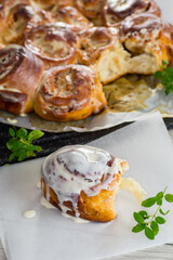 cooked baked sweet cinnabon with cream in baking paper .