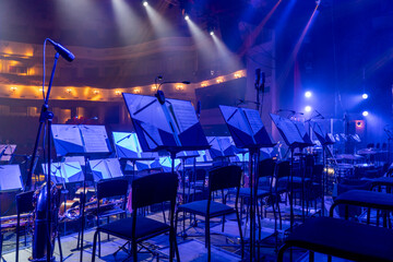 music stands with orchestral notes in the concert hall