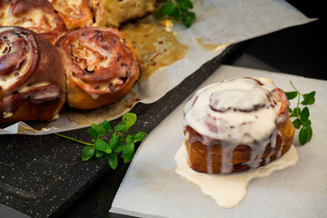 cooked baked sweet cinnabon with cream on black background