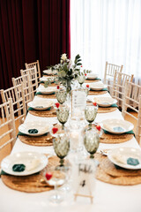 shot of the wedding hall decorated with flowers and lights, tables set with cutlery and beautiful decorations, wedding day