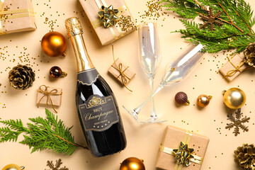 Composition with bottle of champagne, Christmas decorations and gifts on color background