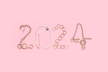 Figure 2024 made of stylish female accessories on pink background