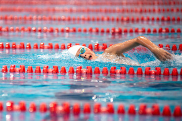 Swimmer swims freestyle swimming style in the pool - 681806346