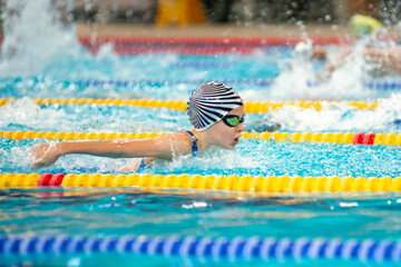 Swimmer girl swims butterfly swimming style in the pool - 681806362