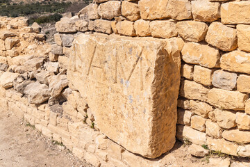 An inscribed stone at the Roman ruins. in Dougga, Tunisia.
