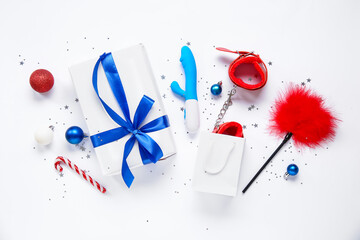 Composition with sex toys and Christmas decorations on white background
