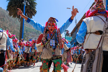 dancers with typical costumes perform choreography at the festivity of the Virgen del Carmen, Paucartambo square, Cusco Peru. - obrazy, fototapety, plakaty