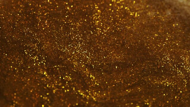 Antique gold. Gold glitter background with sparkling texture. Golden shimmering light, stars sequins sparks and glittering glow foil background. Color Texture close up surface