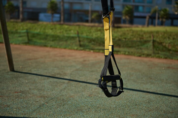 Suspension straps hanging on crossbars on outdoors sportsground