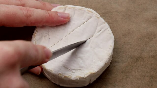 Cut Camembert cheese into strips with a knife. Create a grid pattern on the cheese