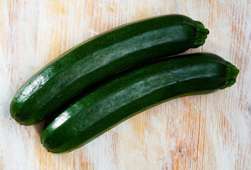 Vegetable ingredients for cooking, organic green zucchini on wooden table