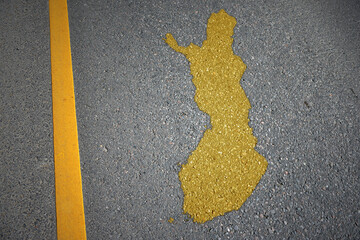 yellow map of finland country on asphalt road near yellow line.