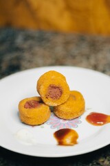 coxinha, cheese balls, mini chicken pot pies, kibbeh, risoles, pastries filled with meat or cheese, Lebanese meat pies, mini sandwiches, codfish fritters, and meat croquettes