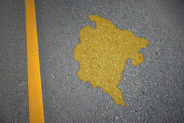 yellow map of montenegro country on asphalt road near yellow line.