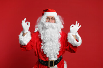 Merry Christmas. Santa Claus showing OK gestures on red background
