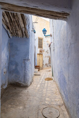 Blue walls on a narrow alley.