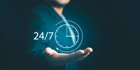 Businessman or Manager Customer Service show hand holding virtual 24-7 with clock for worldwide...