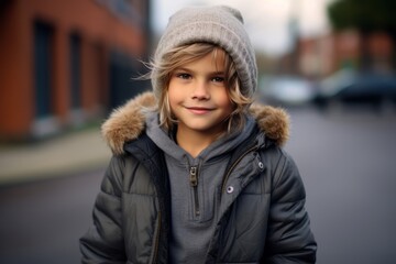Portrait of a cute young girl in a winter jacket and hat.