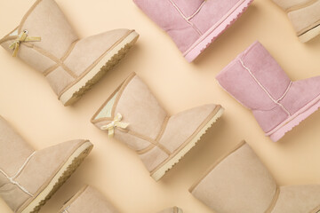 Many woman ugg boots on color background,top view