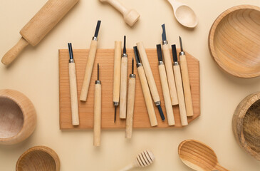 Carpenter tools with wooden objects on color background,top view