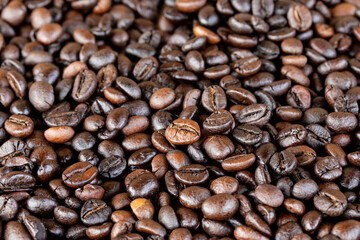 Roasted coffee beans, black coffee background