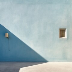 A wall with a subtle stucco texture in pale blue, illuminated by morning light
