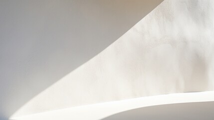 Close-up of a white stucco wall with subtle shadows