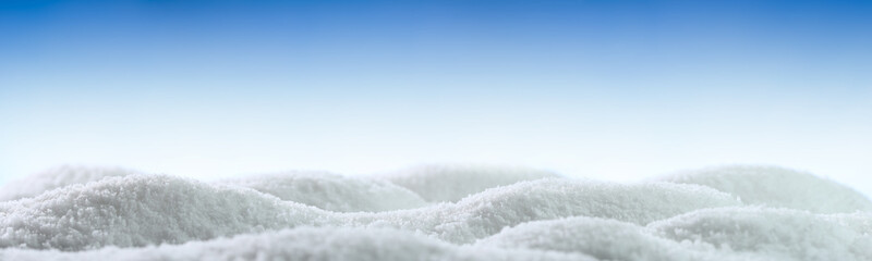Banner of sparkling fluffy white snow hills. Wintertime snow border with blue sky. - obrazy, fototapety, plakaty