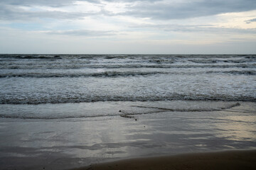 Soft wave of blue ocean on sandy beach. Background.