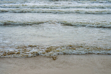 Soft wave of blue ocean on sandy beach. Background.