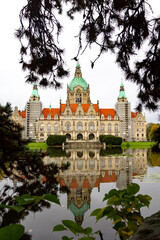 New Town Hall of Hannover city with reflecting and trees around. Lower Saxony, Germany. Vertical view
