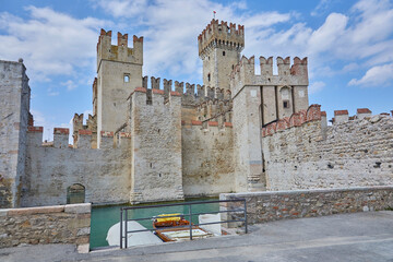 Fototapeta na wymiar Beautiful view of the castle in Sirmone (Castello Scaligero di Sirmione) on Lake Garda. Province of Brescia, Italy.