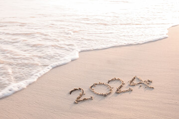 2024 year written on the beach in the sunset time. New Year 2024 concept