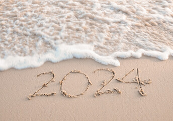 2024 year written on the beach in the sunset time. New Year 2024 concept