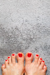 Beautiful woman's vinous burgundy nails with beautiful pedicure. Female feet with bright pedicure...