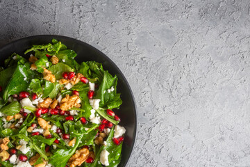 Arugula salad with cheese served with walnuts and pomegranate. Turkish name; Roka salatasi