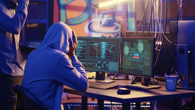 BIPOC hackers in secret headquarters targeting vulnerable unpatched connections, frustrated after failing to get past computer defenses and steal valuable sensitive data, access denied error