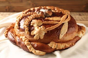 Korovai on tablecloth, closeup. Ukrainian bread and salt welcoming tradition