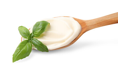 Wooden spoon with tasty mayonnaise and basil isolated on white
