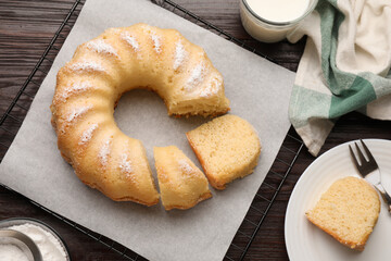 Delicious sponge cake served on wooden table, flat lay