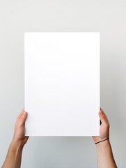 Hand holding blank photo frame board mockup on minimalist white background created with Generative AI Technology - obrazy, fototapety, plakaty