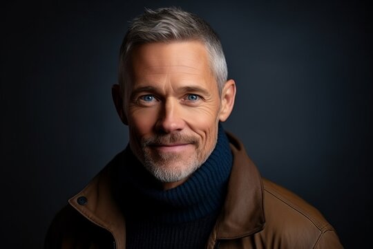 Portrait of a handsome middle-aged man with grey hair.