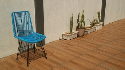 simple chair in blue color against clear gray wall