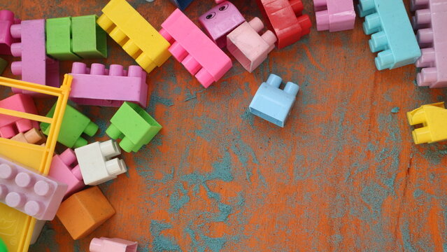 Colorful children's plastic building bricks scattered around.Copy space