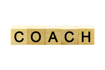 "COACH" text or message short word english letter on a small wooden cubes block with white background.